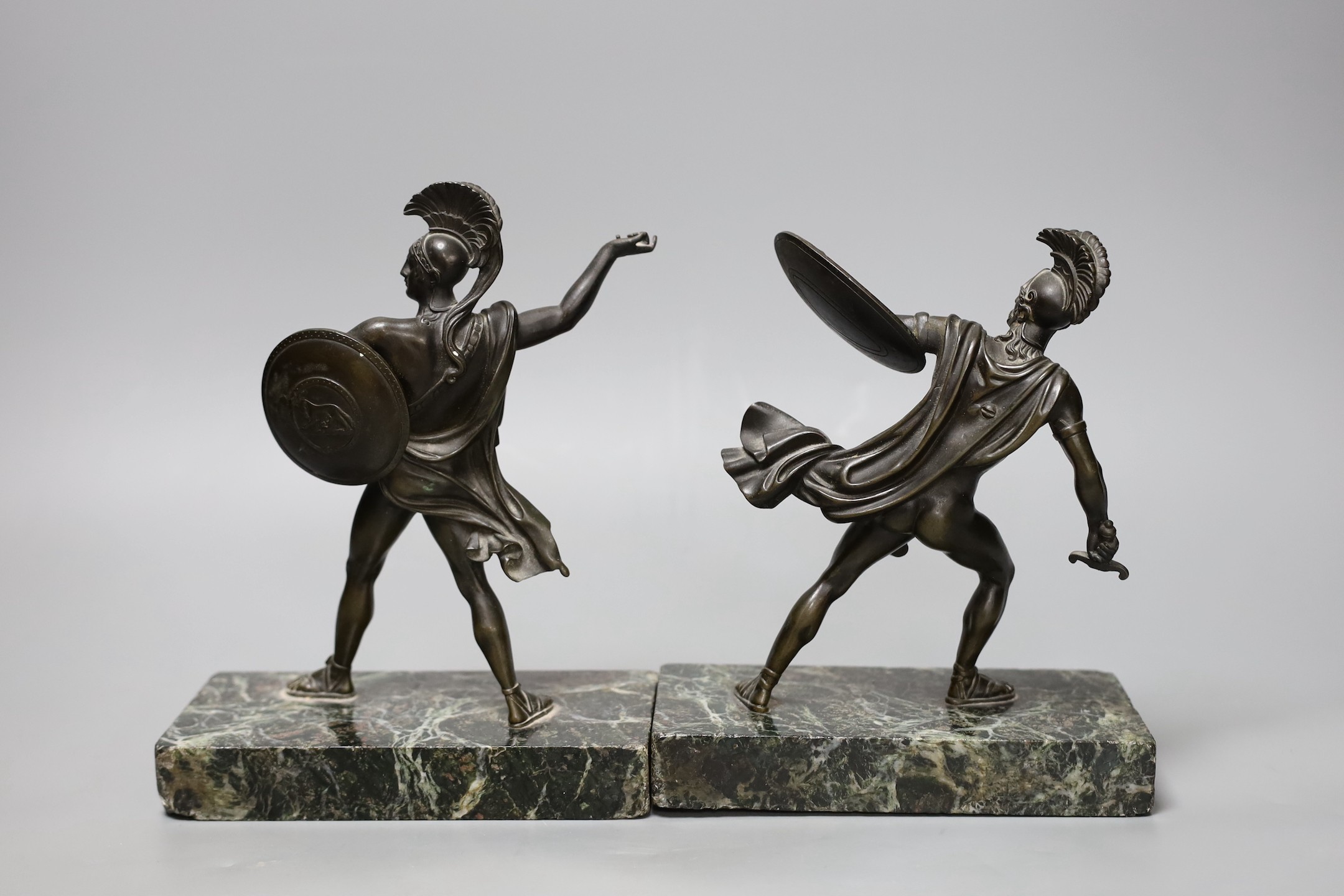 A pair of early 20th century bronze classical warriors, marble bases, tallest 21 cms high